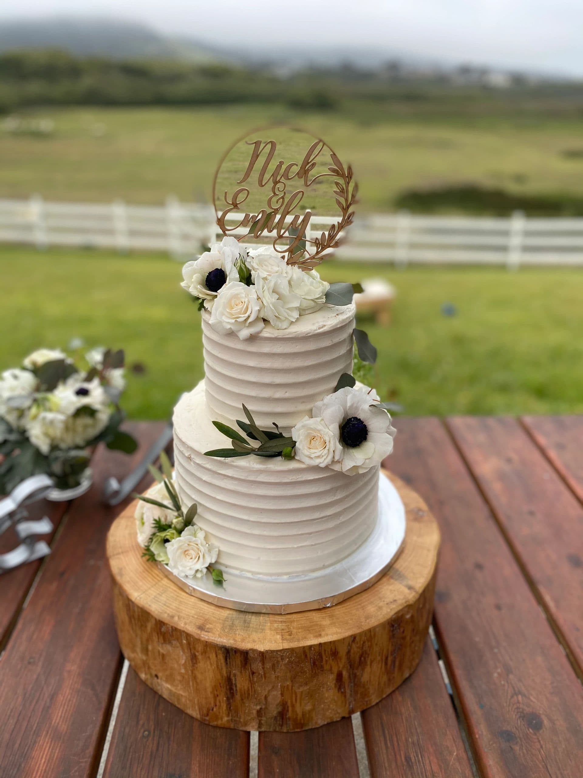 Rustic white tiered cake with anemones